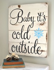 a vintage white Christmas sign with black calligraphy and a blue snowflake is a lovely decoration you can DIY