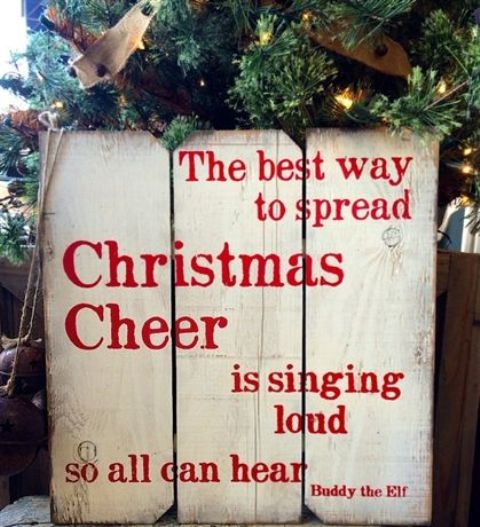 a whitewashed wooden plaque Christmas sign with red letters is a cool rustic holiday decor idea to rock