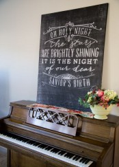 a chalkboard sign with white calligraphy is a lovely decor idea for the holidays and not only – you can change the text when you need it