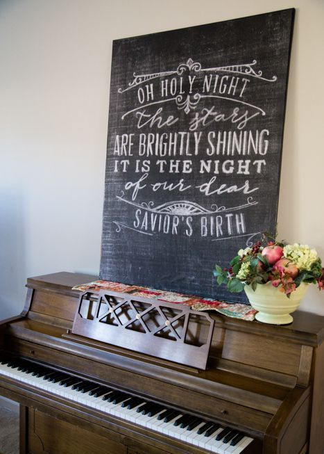 a chalkboard sign with white calligraphy is a lovely decor idea for the holidays and not only - you can change the text when you need it