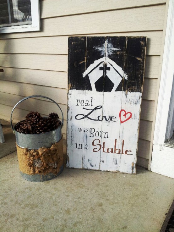 a shabby chic black, white and red Christmas sign with a religious theme is a lovely decor idea for an outdoor holiday space