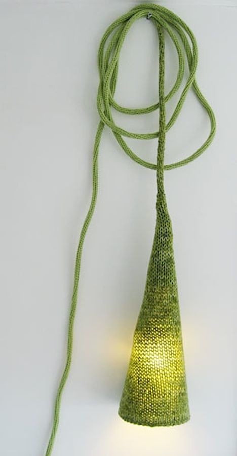 a lamp dressed up with a grene crochet cozie is a lovely idea for the fall and it looks very chic, nice and pretty giving a welcoming touch to the space