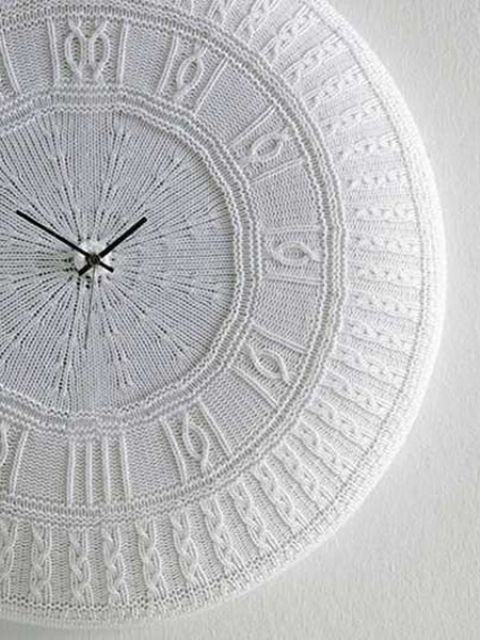 a clock covered with a delicate white crochet cozie is a lovely idea to give a subtle winter feel to the space