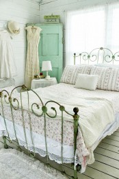 a neutral vintage bedroom with elegant and refined furniture, a mint vintage door in the corner, neutral linens