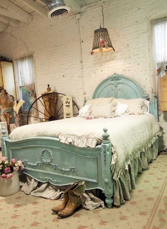 a vintage and shabby chic bedroom with white brick walls, a mint bed, vintage artworks and manequins plus pendant lamps