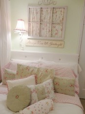 a pastel and floral vintage bedroom with light green walls, a window frame with floral fabric and floral bedding on the bed