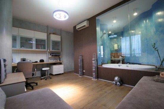 a unique and bold teen bedroom with built-in cabinets and a desk, an L-shaped sofa and a bathtub with glass doors right in the room