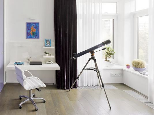 a simple contemporary teen bedroom done in white and neutrals, with a dark curtain, wall shelves and large windows