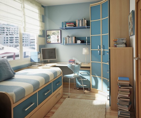 a stylish small blue and tan teen room with a bed with drawers for storage, a corner desk and a curved wardrobe, floating shelves and stacked books
