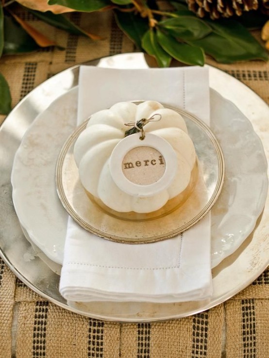 white and mother of pearl porcelain with a gold edge, a white pumpkin and a card for a chic place setting at Thanksgiving