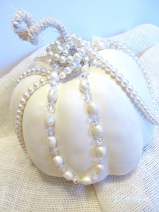 a white pumpkin covered with pearls and with twine is a beautiful glam decoration for Thanksgiving