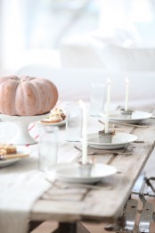 a natural and whitewashed Thanksgiving table setting with a whitewashed pumpkin, a striped runner and white porcelain