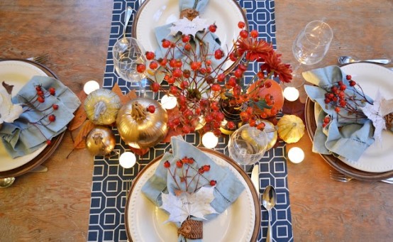 powder blue napkins and a bold blue and white printed table runner paired with gold veggies and bold dried blooms and berries look cool