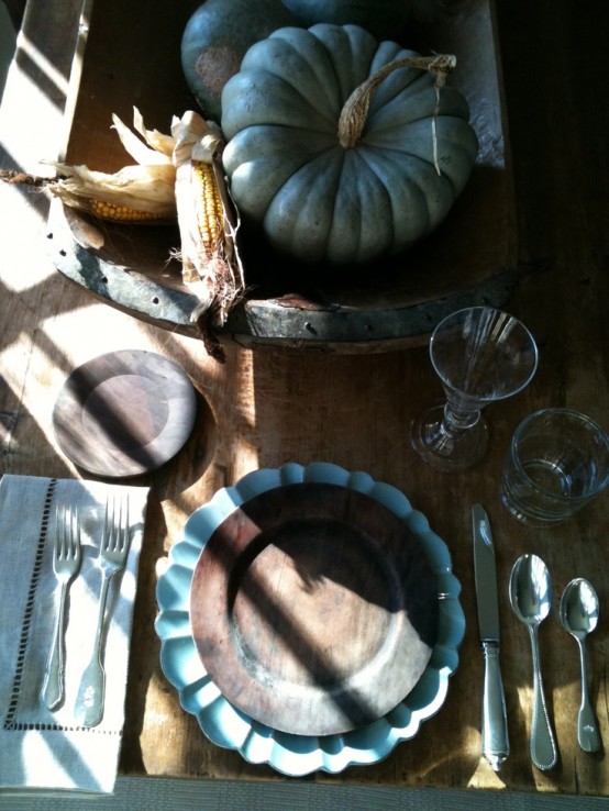 blue pumpkins and chargers add a refreshing touch to this rustic Thanksgiving tablescape