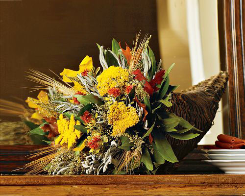 a cornucopia filled with bright blooms, foliage and wheat is a perfect Thanksgiving centerpiece to rock