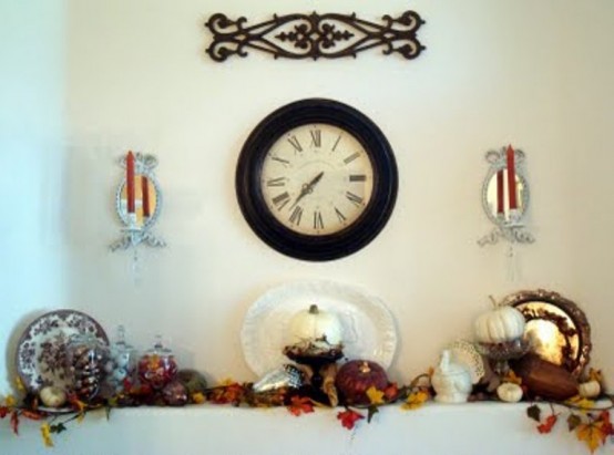 a vintage Thanksgiving mantel with bold leaves, pumpkins, gourds, faux acorns in jars and a vintage clock is a chic piece