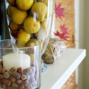 glasses with acorns and pears, twine balls and fall leaves will help you to create a lovely and all-natural Thanksgiving mantel