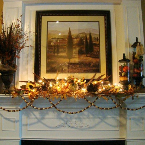 dried leaves, pumpkins, feathers, wooden bead ggarlands and lights are all you need for a lovely Thanksgiving mantel in natural shades