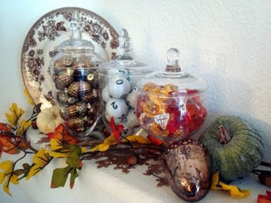 a vintage Thanksgiving mantel with bold leaves, pumpkins, faux pinecones, a bold printed plate is a chic and elegant idea