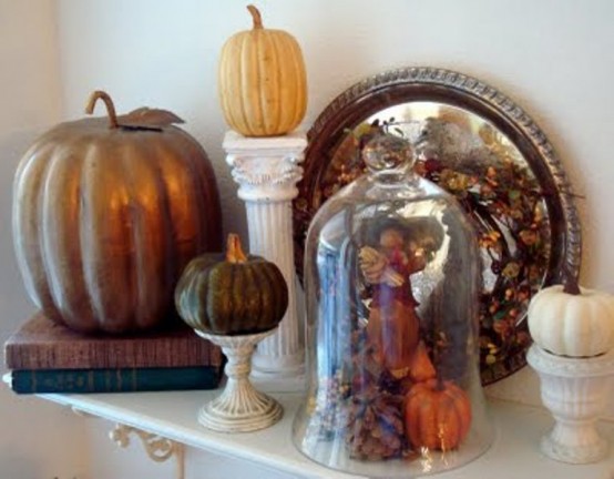 a vintage Thanksgiving mantel with faux pumpkins of various sizes, pinecones and dired leaves is a lovely and cool idea to rock