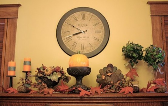 a vintage Thanksgiving mantel with faux leaves, turkeys, greenery topiaries, candles and faux berries is a lovely decor idea to rock