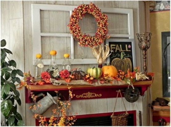 a rustic vintage Thanksgiving mantel with bold blooms, leaves, pumpkins of various materials, a bold berry wreath and dried leaves
