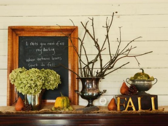 a fall and Thanksgiving mantel with green hydrangeas, branches, a chalkboard sign, a pumpkin in a sugar pot and pears and pinecones