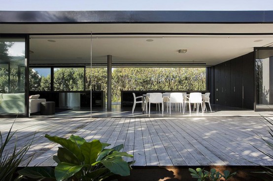 The House That Consists Of Two Habitable Areas Connected By Floating Pavilion