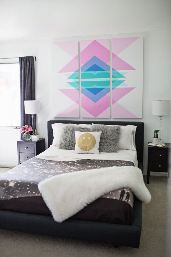 a contrasting black and white bedroom with black furniture, with pretty bedding and a super colorful geometric accent artwork that creates a mood