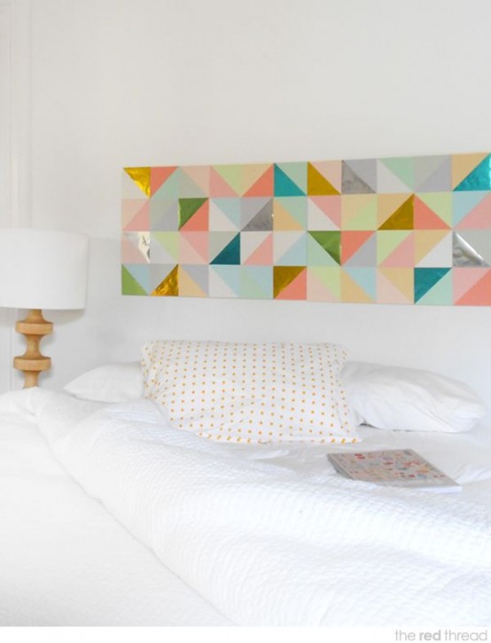 a neutral bedroom with neutral bedding and a colorful geometric artwork over the bed is a lovely idea to rock
