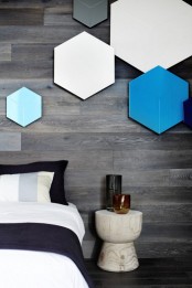 a textured wooden accent wall looks nice in a modern bedroom