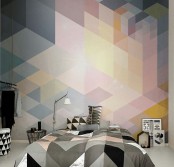 a cool bedroom with a bright geometric accent wall, a bed with geometric print bedding, black and white baskets and books and decor