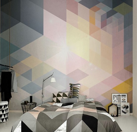 a cool bedroom with a bright geometric accent wall, a bed with geometric print bedding, black and white baskets and books and decor