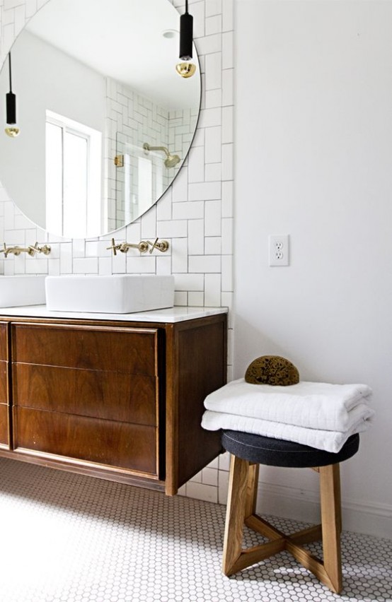 a chic mid-century modern bathroom in neutrals, with subway and hex tiles, a dark stained vanity and stool and pendant lamps