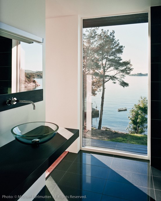 Twofold House In Black Stained Wood With Natural Wood Between The Window Partitions