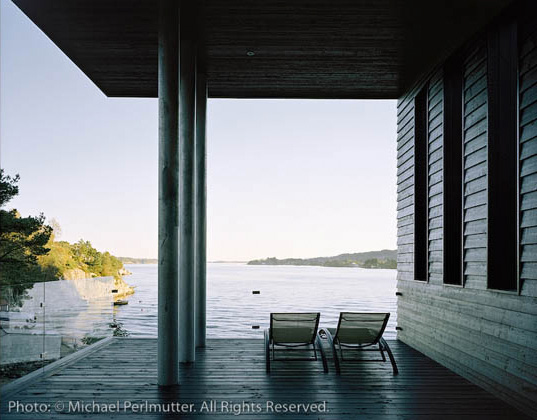 Twofold House In Black Stained Wood With Natural Wood Between The Window Partitions