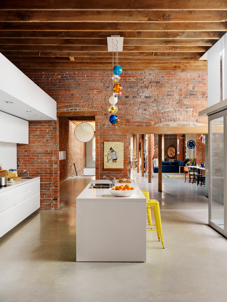 ultra modern glossy white kitchen in an industrial environment