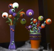 a purple and orange vase with bold eyeball bouquets is a creative and fun decoration for Halloween