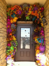 crazy colorful entrnace styling in bold colors, with ribbons, pops, skeletons, pumpkins, spiders and skulls