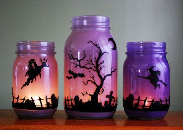 ombre pink and purple jars with scary scenes made with black paper and candles are easy and stylish Halloween decorations