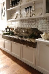 elegant white cabinets with dark stone countertops look very chic and vintage meets contemporary