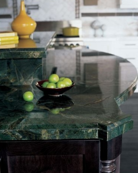 dark cabinets and green stone countertops create a chic moody look in the kitchen