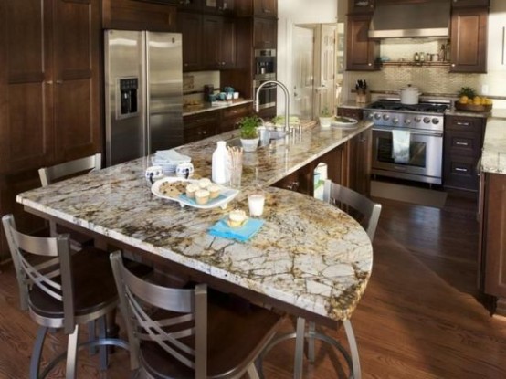 dark stained wooden cabinets and grey stone countertops create a stylish combo for an elegant kitchen with a rustic feel