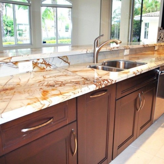 rich stained wooden cabinets with neutral stone countertops that create a bold contrasting look