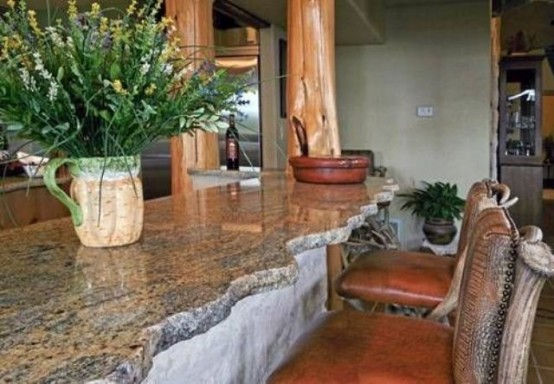 a neutral kitchen island with a natural stone countertop with a rough edge looks rustic and relaxed