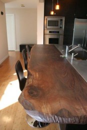 a rich stained wooden countertop with a living edge is a chic idea with a modern feel