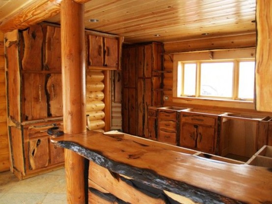a full wooden kitchen with a matching wooden countertop with a living edge for a more rustic feel