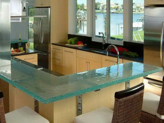 a blue glass countertop is a modern idea for a kitchen, though it's not very durable, it's stylish