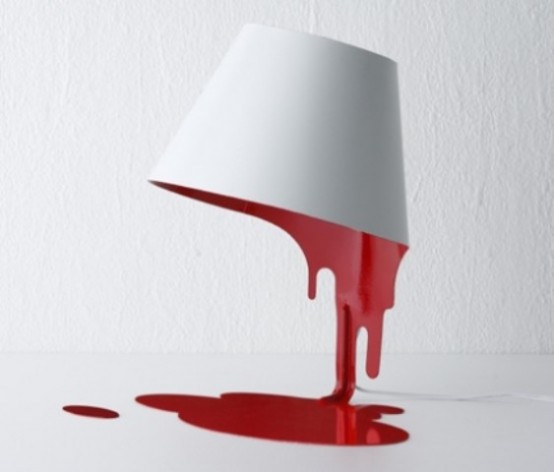 a unique table lamp showing off a white bowl with red something dripping down is amazing for giving a whimsy feel to the space