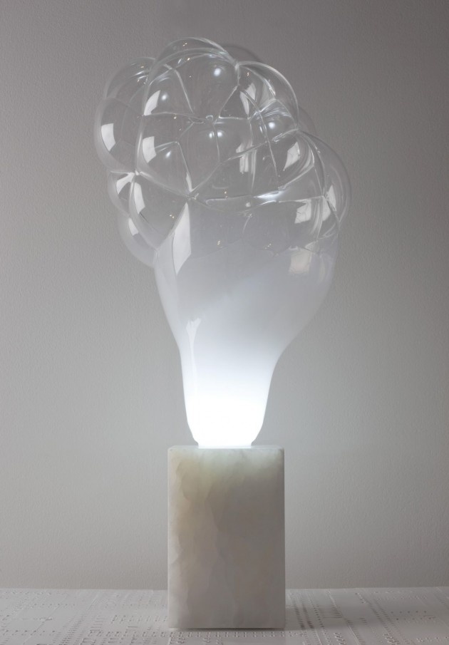 a unique bubble inspired table lamp with a white stone base and an unusual bubble like top